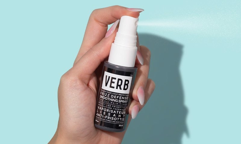 Hand spraying spray bottle