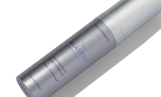 The Alastin Skincare Regenerating Skin Nectar in a white bottle with a silver lid.