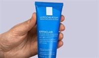 Hand holding a tube of La Roche-Posay Effaclar Shine Control Clay Mask
