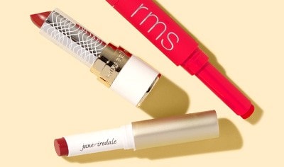 Uncapped tubes of red lipstick by jane iredale and RMS Beauty.