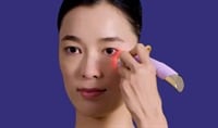 Woman applying the FOREO FAQ 101 RF Facial Rejuvenation Device to her face