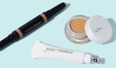 Concealers from Laura Mercier, Ere Perez and jane iredale on a light blue background