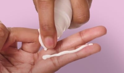 Woman applies Anthelios UV Correct SPF to her finger