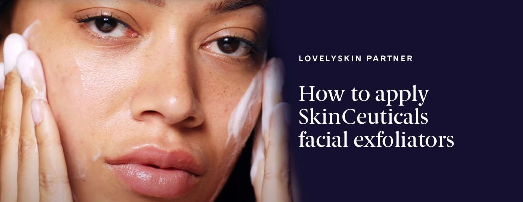 A woman looking forward, washing her face with a foaming cleanser.