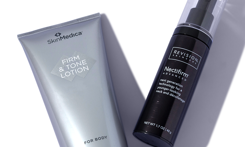 A body oil next to a firming body cream.