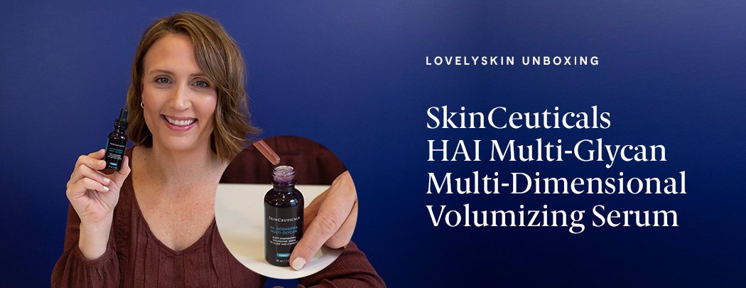 A woman with brown hair holding a bottle of SkinCeuticals HAI Multi-Glycan Multi-dimensional Volumizing Serum and smiling.