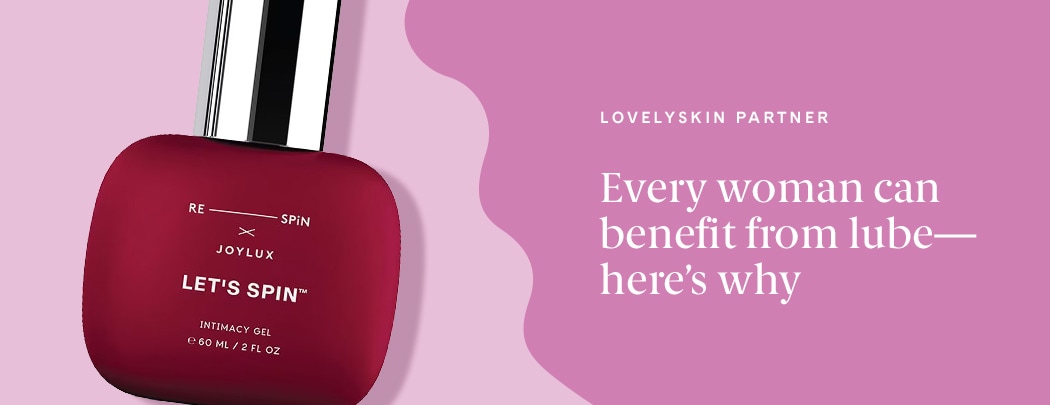 A red bottle of Joylux LET'S SPIN Intimacy Gel lays on a pink background.