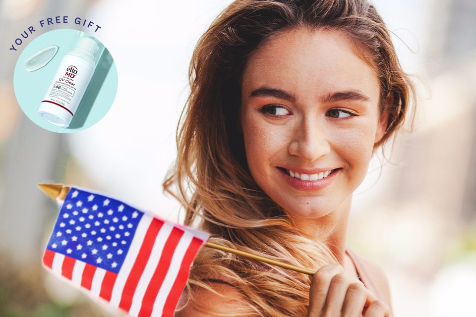 Patriotic woman smiling with the American flag
