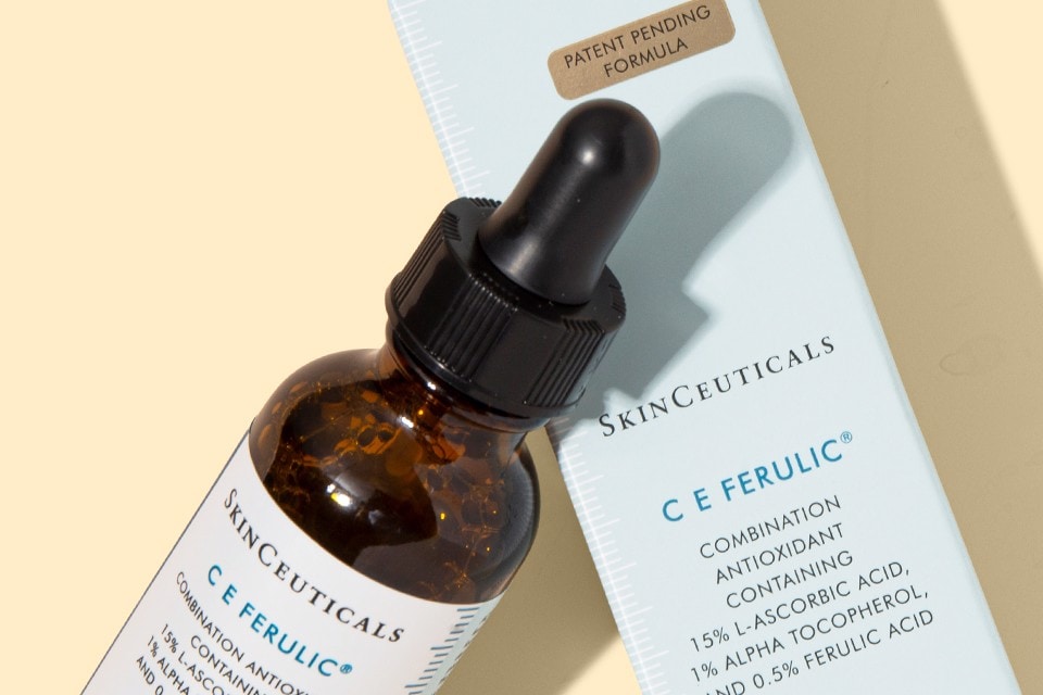 SkinCeuticals C E Ferulic serum bottle and box on a light yellow background with soft shadows
