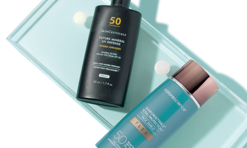 Sunscreens from SkinCeuticals and Colorescience with a drop of product next to each.