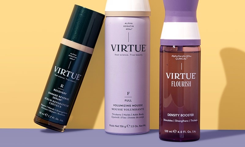 Virtue products displayed upright against a warm yellow and purple background