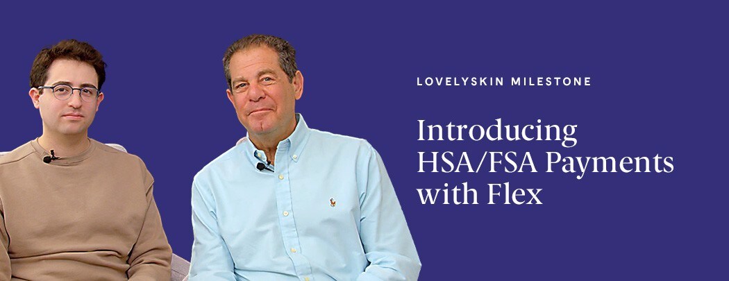 Two men, one with dark brown hair and one with light brown hair, sit next to one another.