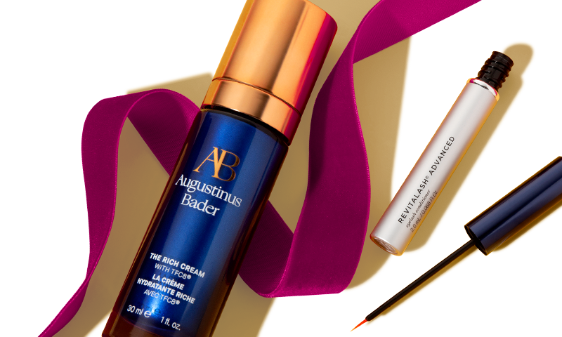 Augustinus Bader and RevitaLash products with a holiday ribbon