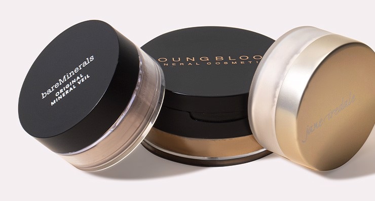 Three lidded pots of loose setting powder on an off-white background