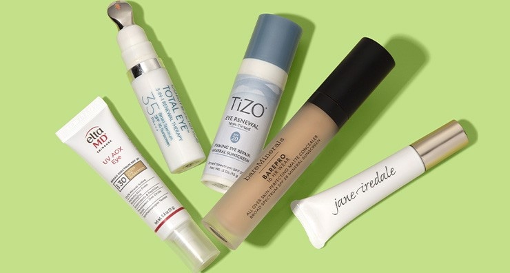 Eye sunscreens by EltaMD, Colorescience, TiZO, bareMinerals and jane iredale on a light green background