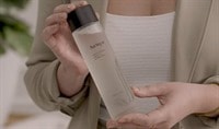 Woman holding a bottle of the Jurlique Activating Water Essence+