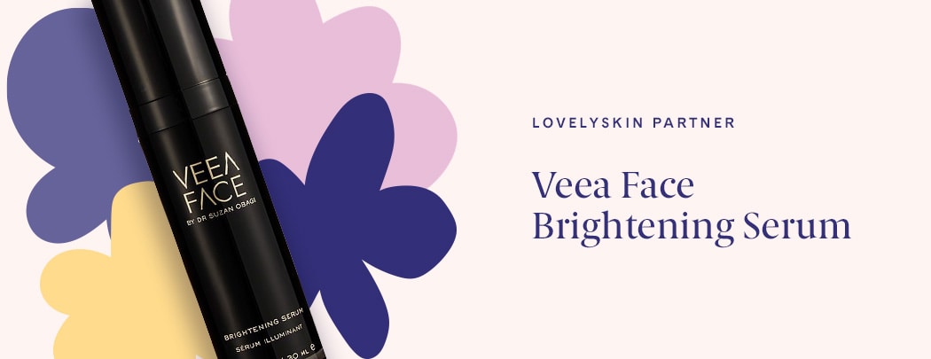 A black bottle of Veea Face Brightening Serum lays over four illustrated flowers. The label on the bottle is in gold.