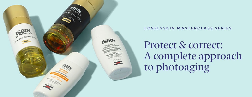 A smattering of ISDIN products lay on a blue background. There are two sunscreens, a vitamin C serum, and a retinoid serum.