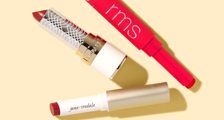 Uncapped tubes of red lipstick by jane iredale and RMS Beauty.