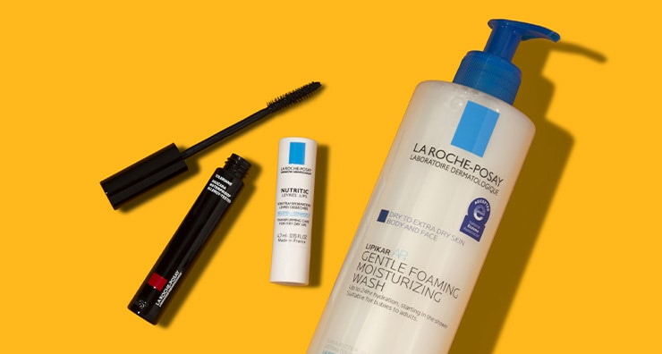 La Roche-Posay mascara, lip balm and face wash on an orange background