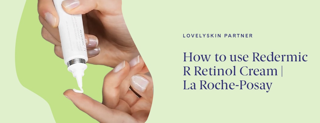 One hand dispensing retinol cream onto an index finger