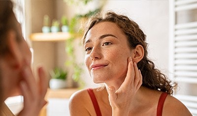 woman checking her complexion