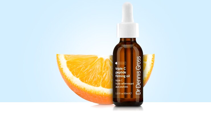 dr dennis gross triple c peptide firming oil next to an orange. Why you should purchase dr dennis gross skin care. 