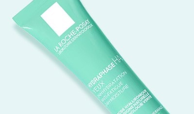 A green tube of La Roche Posay Hydraphase Eye Cream on a white background