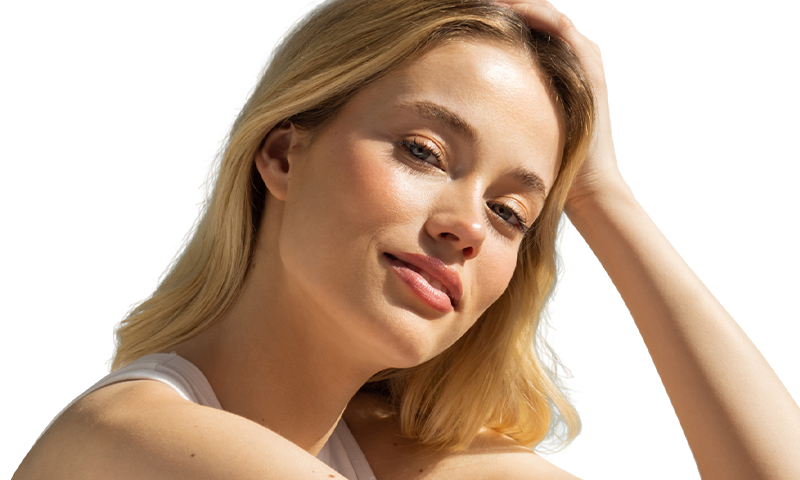 Young, blonde-haired woman smiling and resting her head on her hand