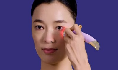 Woman applying the FOREO FAQ 101 RF Facial Rejuvenation Device to her face