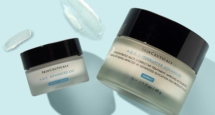 Lidded jars of SkinCeuticals A.G.E. Advanced Corrective Cream and eye cream on a light. blue background.