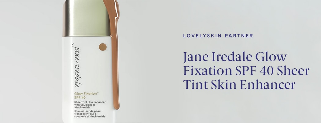 A bottle of Jane Iredale Glow Fixation SPF 40 sits with product dripping over it.