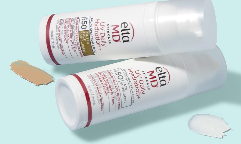 Product bottles laying on each other next to swatches.