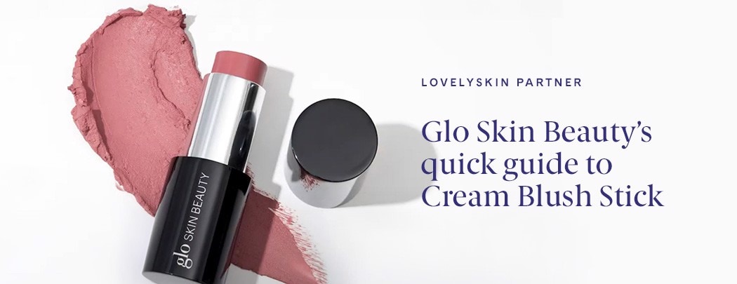 An open tube of Glo Skin Beauty Cream Blush Stick with a large pink swatch of lipstick beneath.