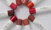 Ten Ere Perez Coco Crayons are laid in a circle with their colored ends touching one another.