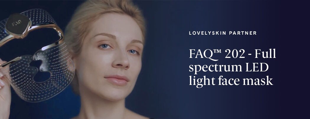 A woman with fair skin and light hair holds the clear and gold FOREO FAQ 202 face mask.