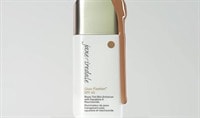 A bottle of Jane Iredale Glow Fixation SPF 40 sits with product dripping over it.