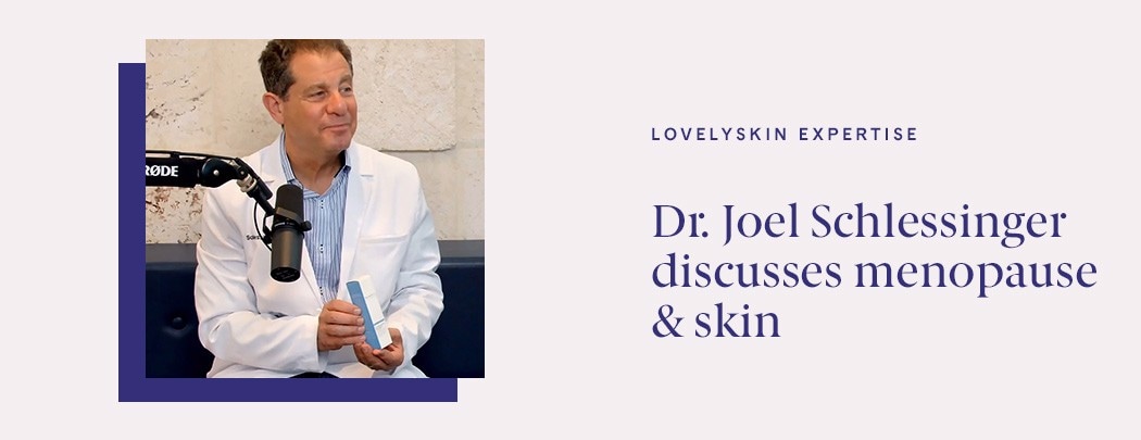 A dermatologist in a doctor's coat smiling and sitting next to a podcast mic, holding a box of skin care.