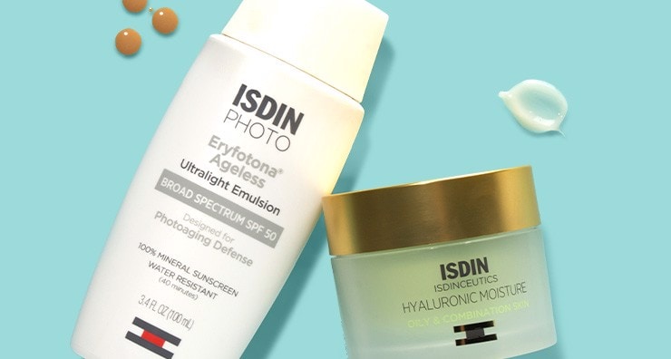 Containers of ISDIN sunscreen and moisturizer on a turquoise background.