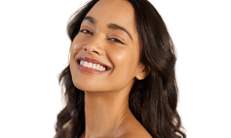 Woman smiling with healthy, wavy hair