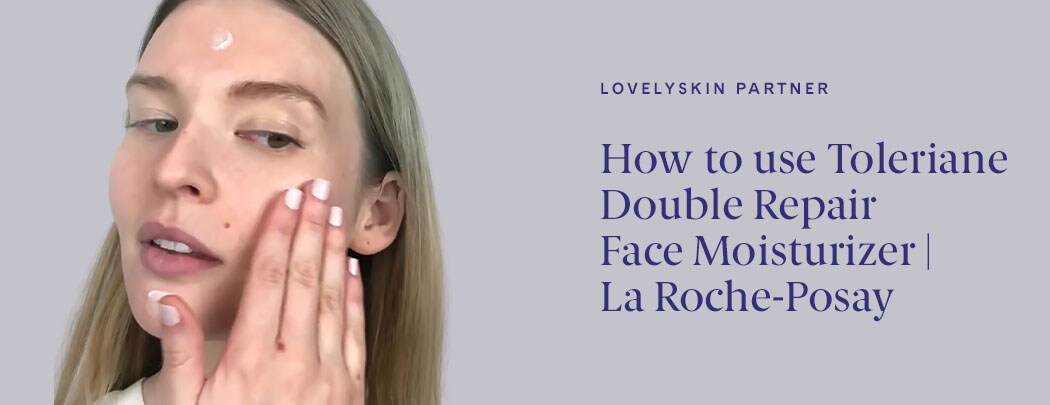 Young woman applying moisturizer to her face