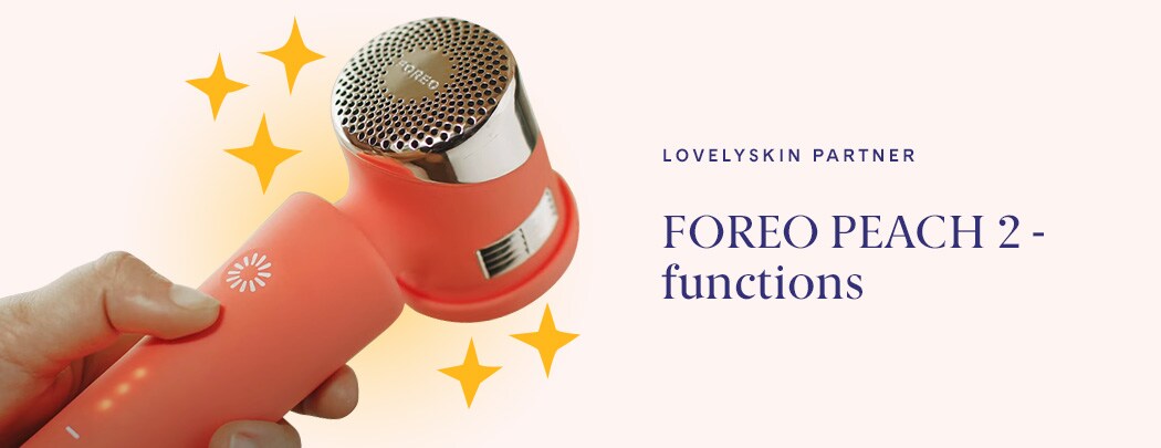Hand holding FOREO PEACH 2