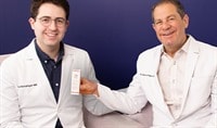 Drs. Joel and Daniel Schlessinger sit next to one another while smiling. Dr. Joel holds a box of EltaMD UV Clear Blemish-Prone & Oil Balancing SPF 50.