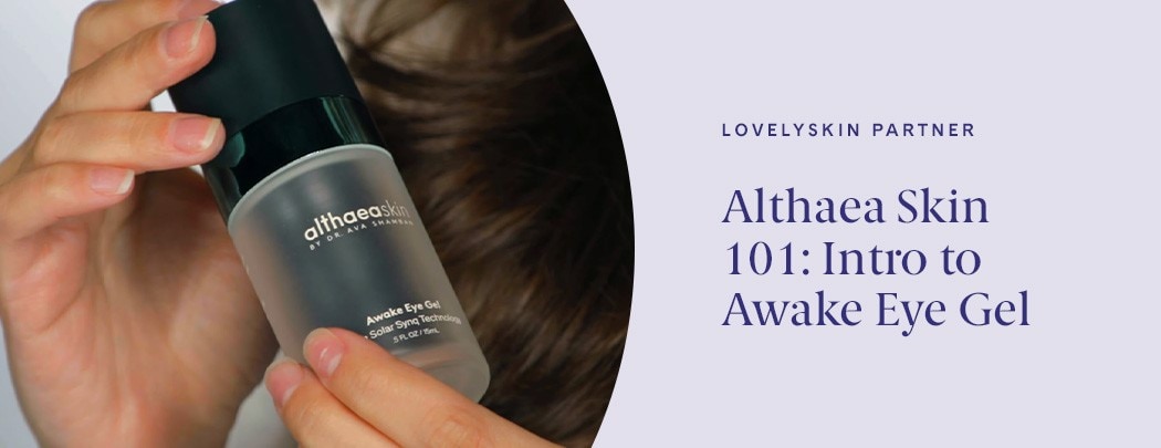 A woman with medium, olive-toned skin holds a bottle of Althaea Skin Awake Eye Gel. The photo is close up on her hands and the bottle.