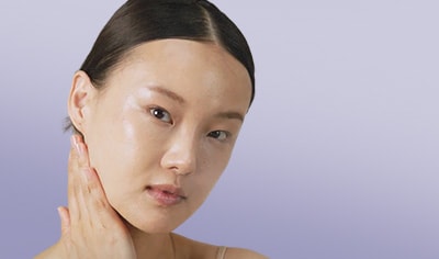 Young woman with her hand on her neck