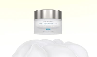 SkinCeuticals Triple Lipid Restore 2:4:2 Moisturizer floating above a table. Shop LovelySkin for SkinCeuticals top-rated skincare products. 