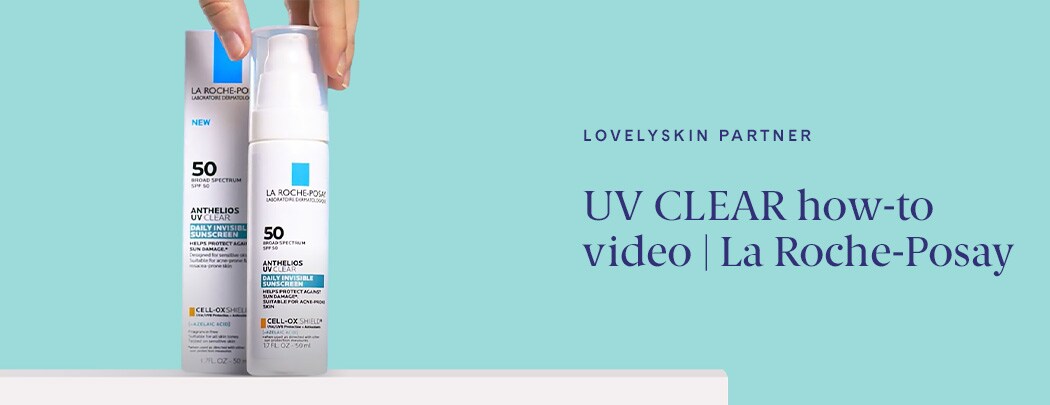 A hand reaching for a sunscreen lotion in a pump container next to its packaging