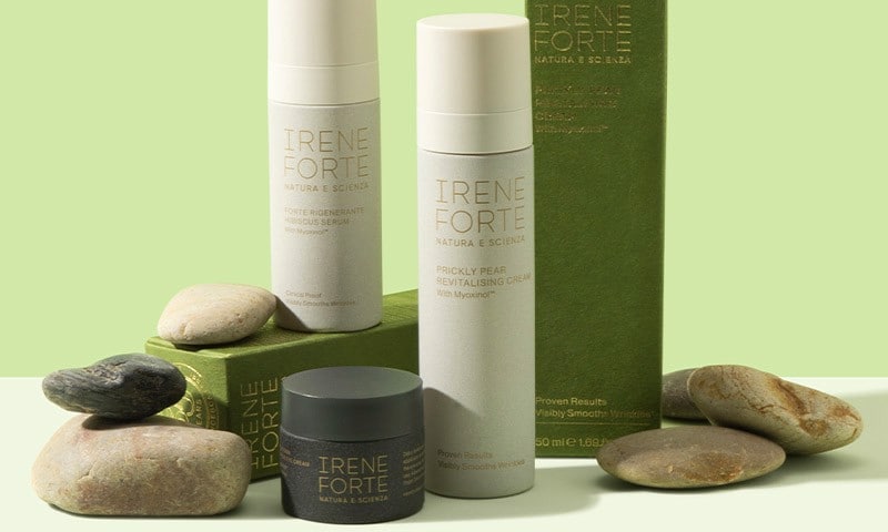 Irene Forte skin care products, including Hibiscus Serum and Prickly Pear Revitalising Cream, arranged with natural stones