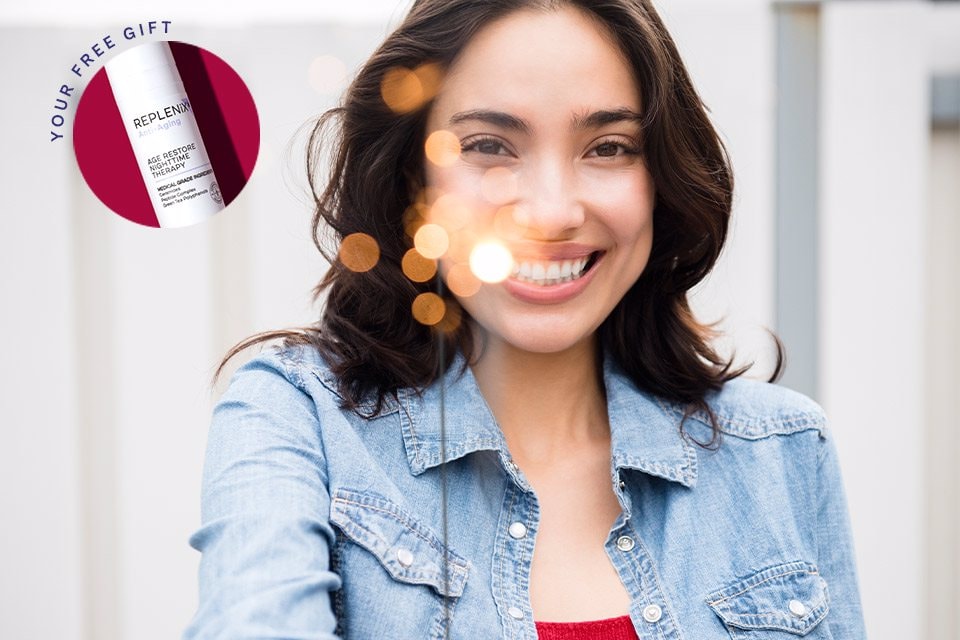 Woman holding a sparkler and smiling