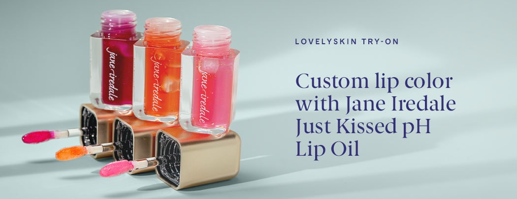 Jane Iredale Just Kissed pH Lip Oil sits open, resting on the precision applicators, showing off each of the three shades.